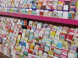 multiple commercial greeting cards in rack in store