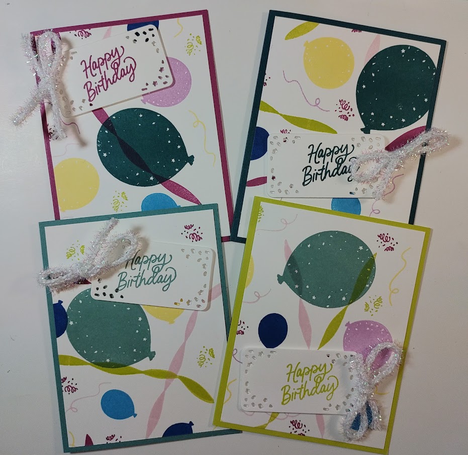 colorful pic of 4 cards made by stamping balloon and streamer images randomly on white cardstock then cut to fit a 4 1/4" x 5 1/2" card base.