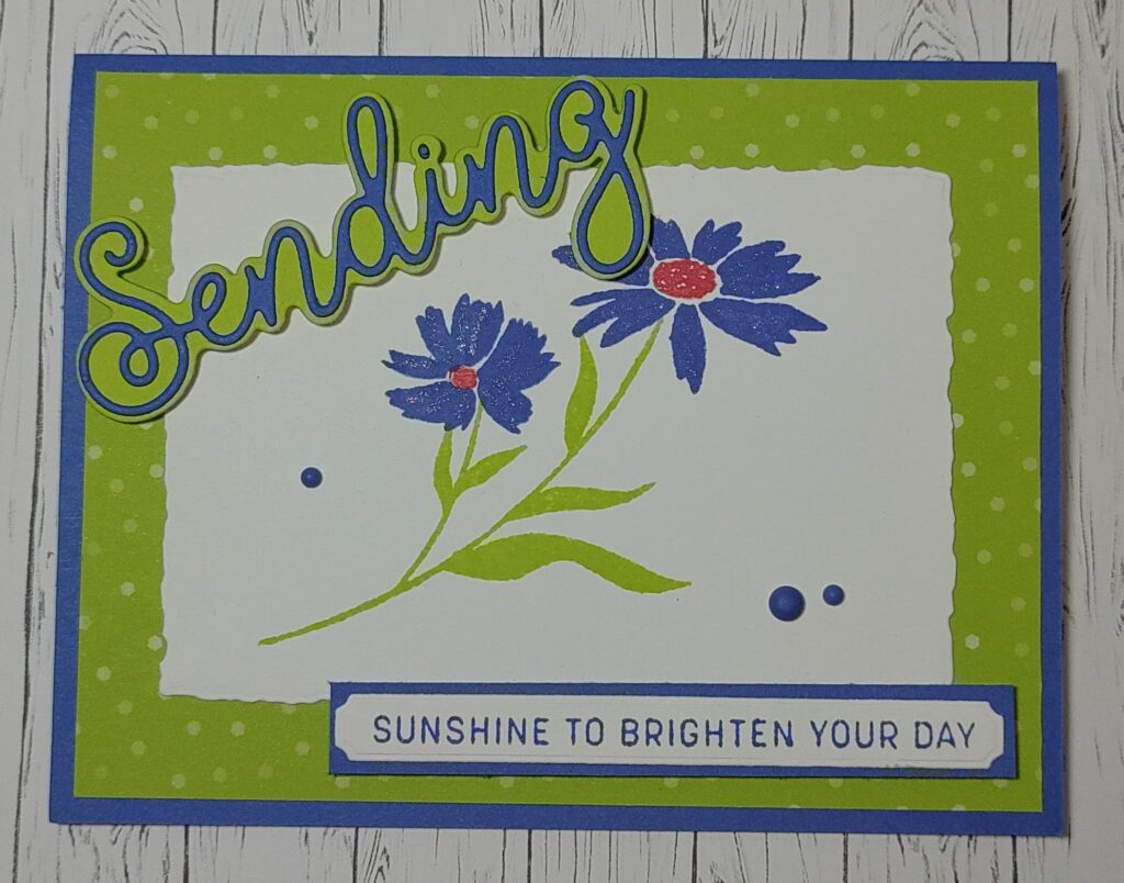card made with sending smiles bundle, blue flower on front