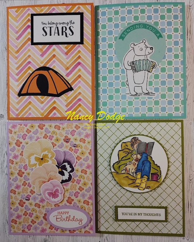 4 colorful card fronts made during mystery card class on June 4, 2023.
