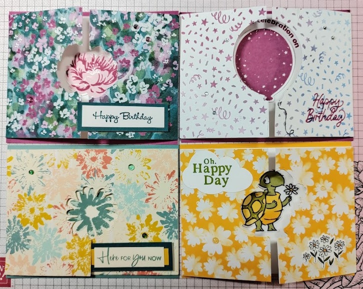 4 colorful cards made with stamps, designer series paper with2 flaps on either side
