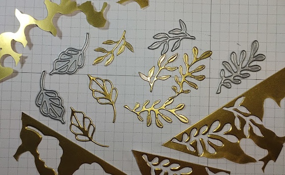 scrap gold cardstock cut with dies on hand